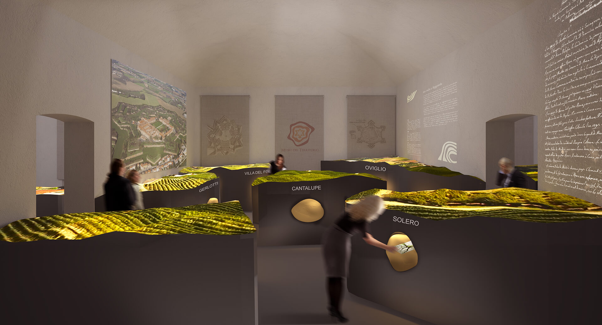An immersive exhibition hall features illuminated topographical models representing the region, arranged on large, dark islands labeled with place names. Text and graphic projections appear on the walls, while visitors observe and interact with the models.