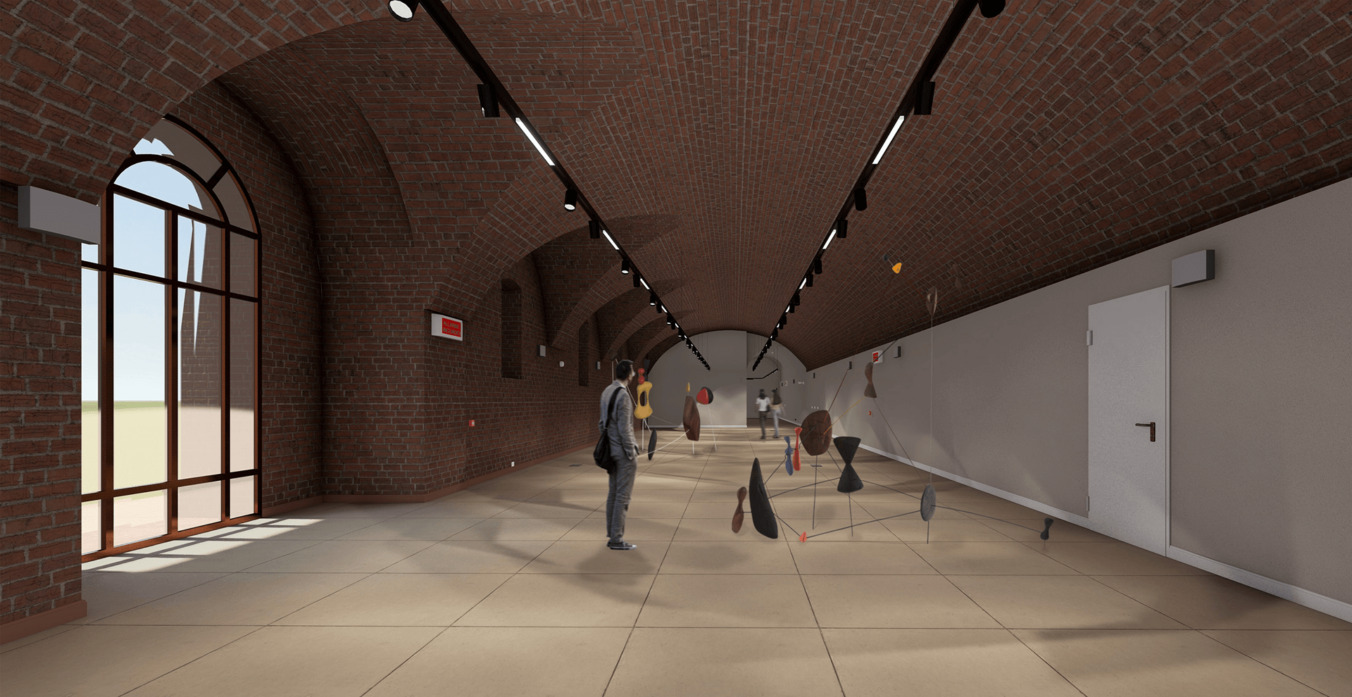 L'immagine mostra un ampio e moderno spazio espositivo, probabilmente all'interno di una galleria d'arte. Ecco una descrizione dettagliata: Dettagli principali: Struttura e materiali: Il soffitto è a volta, realizzato con mattoni a vista che conferiscono un'atmosfera storica e rustica, mentre le pareti laterali sono lisce e dipinte in un colore chiaro, creando un contrasto elegante con il soffitto. Il pavimento è in piastrelle beige, creando un ambiente luminoso e pulito. Luce naturale: Una grande finestra, visibile a sinistra, lascia entrare una quantità abbondante di luce naturale che illumina la stanza e crea riflessi interessanti sul pavimento. Illuminazione artificiale: Le luci da incasso sul soffitto e i faretti direzionabili forniscono un'illuminazione diretta sui pezzi di arte esposti, facendo risaltare le sculture e gli oggetti presenti nell'ambiente. Esposizione d'arte: Al centro della stanza sono presenti delle sculture sospese su supporti metallici. Le opere d'arte hanno forme astratte e colorate, aggiungendo un tocco di modernità all'ambiente. Persone: Ci sono due persone che esplorano l'esposizione, una sta osservando una scultura mentre l'altra si sta avvicinando a un'altra opera. Le persone sono vestite in modo casual, contribuendo a un'atmosfera rilassata e accogliente. Atmosfera: L'ambiente ha un'aria moderna e raffinata, con un perfetto equilibrio tra la struttura storica e l'arte contemporanea. L'illuminazione gioca un ruolo fondamentale nel mettere in risalto le opere esposte, mentre le ampie finestre e l'architettura a volta creano un'atmosfera ariosa e spaziosa. La presenza delle persone suggerisce un luogo di incontro culturale, invitando i visitatori a esplorare e apprezzare l'arte in un ambiente confortevole e stimolante.